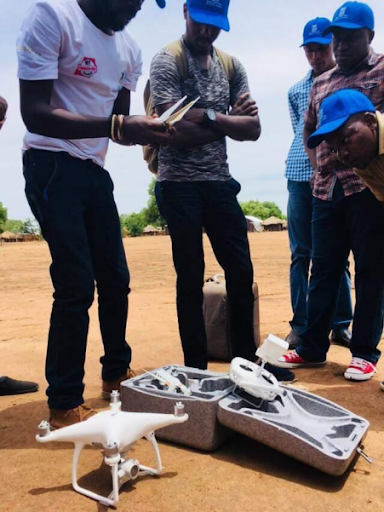 a Pilot demonstrating how to unpack a drone from its casing and  assembling it